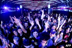 Festival goers watch the Stokes at Samsung Galaxy Life Fest at SXSW 2016 on March 11, 2016 in Austin, Texas.