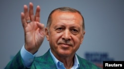 Turkish President Recep Tayyip Erdogan reacts during an election rally in Istanbul, June 23, 2018. 