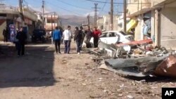 In this photo released by the Syrian official news agency SANA, a damaged area is seen after a car bomb explosion in Qatana, southwest of Damascus, Syria, Dec. 13, 2012.