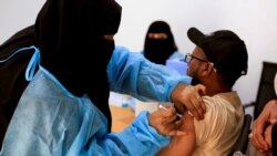 FILE - A man receives the AstraZeneca vaccine against COVID-19 at a medical center in Taiz, Yemen, April 23, 2021.