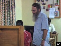 Reverend Chris Jenkins, education coordinator for the Jesuit Refugee Service's Kakuma Camp education program, works with a student, Aug 2010