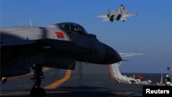 FILE - A live-fire drill using a Chinese aircraft carrier and jets is carried out in the Bohai sea, China, Dec. 14, 2016. 