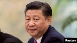 FILE - China's President Xi Jinping looks on during a meeting with Laos' Prime Minister Thongloun Sisoulith in Beijing, China, Dec. 1, 2016. 