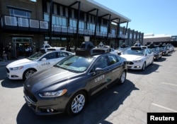 A fleet of Uber's Ford Fusion self driving cars are shown during a demonstration of self-driving automotive technology in Pittsburgh, Pennsylvania, Sept. 13, 2016.