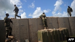FILE - Somali soldiers patrol at the Sanguuni military base, about 450 km south of Mogadishu, Somalia, June 13, 2018.