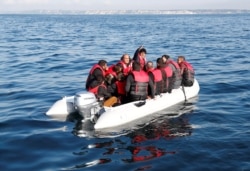 FILE - Migrants who launched from the coast of northern France cross the English Channel in an inflatable boat near Dover, Britain, Aug. 4, 2021.