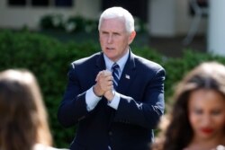 FILE - Vice President Mike Pence speaks to attendees after a White House National Day of Prayer Service in the Rose Garden of the White House, May 7, 2020, in Washington.
