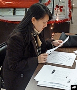 Substitute Santa Erica sifts through letters before deciding which child she will buy for.