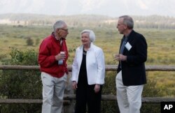Federal Reserve Chair Janet Yellen, center, Stanley Fischer, left, vice chairman of the Board of Governors of the Federal Reserve System, and Bill Dudley, the president of the Federal Reserve Bank of New York, stroll together before Yellen's speech at Jackson Lake Lodge in Grand Teton National Park, north of Jackson Hole, Wyoming, Aug. 26, 2016.