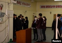 Customs officials are seen onboard of the North Korean ship Mangyongbong-92 carrying the Samjiyon art troupe at Mukjo port in Donghae, South Korea, Feb. 6, 2018