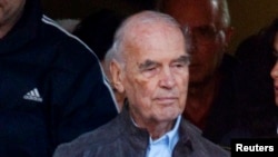 Convicted former Nazi SS captain Erich Priebke (L) leaves after attending a mass at a church in northern Rome, (File photo).