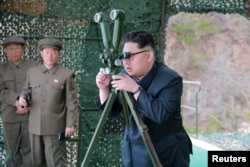 A photo shows North Korean leader Kim Jong Un focusing on the underwater test-fire of a strategic submarine ballistic missile in this undated photo released by North Korea's Korean Central News Agency (KCNA) in Pyongyang, April 24, 2016.