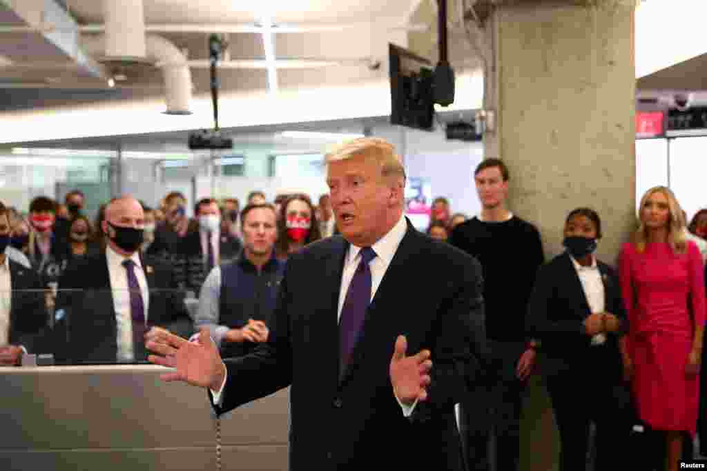 U.S. President Donald Trump greets staff members as he visits his presidential campaign headquarters on Election Day in nearby Arlington, Virginia, Nov. 3, 2020. 