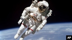 This Feb. 7, 1984 photo made available by NASA shows astronaut Bruce McCandless II, participating in a spacewalk a few meters away from the cabin of the Earth-orbiting space shuttle Challenger, using a nitrogen-propelled Manned Maneuvering Unit.