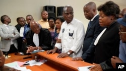Accompanied by his wife and his lawyers, Congo opposition candidate Martin Fayulu, center, petitions the constitutional court following his loss in the presidential elections in Kinshasa, Congo, Jan. 12, 2019.