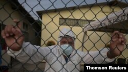 Doctor Bolivar Jalca, who is treating patients experiencing symptoms consistent with COVID-19, poses for a photograph outside Manglaralto Hospital, in Manglaralto, Ecuador, May 2, 2020.