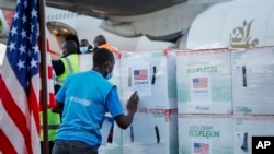 FILE - A UNICEF worker checks boxes of the Moderna coronavirus vaccine, donated by the U.S. government via the COVAX facility, after their arrival at the airport in Nairobi, Kenya, Aug. 23, 2021. 