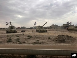 Iraqi tanks deploy in the village of Bashir, south of Kirkuk, Iraq, Oct. 13, 2017.