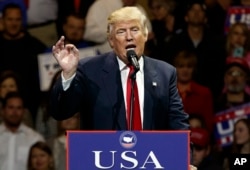 FILE - President-elect Donald Trump gestures as he speaks during a "USA Thank You" tour event in Cincinnati, Dec. 1, 2016.
