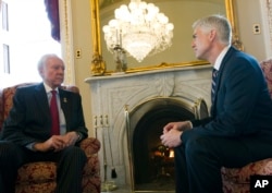 FILE - Supreme Court Justice nominee Neil Gorsuch, right, meets with Sen. Orrin Hatch, R-Utah, in Hatch's office on Capitol Hill in Washington, Feb. 1, 2017.