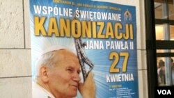 Posters all around town say “Communal Celebration of the canonization of John Paul II, April 27,” Cracow, Poland, April 22, 2014. (Jerome Socolovsky/VOA)