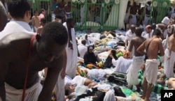 Muslim pilgrims gather around the victims of a stampede in Mina, Saudi Arabia during the annual hajj pilgrimage, Sept. 24, 2015.