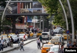 FILE - Taxi drivers wait for costumers in Kizilay Square, in Ankara, Turkey, June 17, 2013.