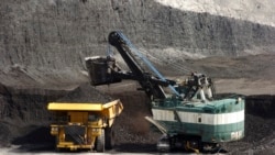 FILE - A mechanized shovel loads a haul truck with coal at the Spring Creek coal mine near Decker, Mont., April 4, 2013. A federal judge in Montana says the Trump administration failed to consider the environmental effects of resuming coal sales from fede