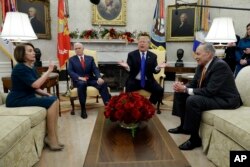 President Donald Trump and Vice President Mike Pence meet with Senate Minority Leader Chuck Schumer, D-N.Y., and House Minority Leader Nancy Pelosi, D-Calif., in the Oval Office of the White House, Dec. 11, 2018, in Washington.
