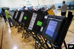 FILE - An electronic voting machine in Columbus, Ohio, Nov. 3, 2015. Democrats and Republicans compete in primaries and caucuses in at least 11 states and one U.S. territory on Tuesday.