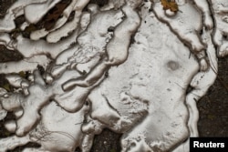 Melted metal from an abandoned car destroyed by the Camp Fire is seen in Paradise, California, U.S., Nov. 10, 2018.