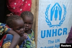 Children stand at the door of their house at a camp for internally displaced people in Maiduguri, Nigeria Nov. 29, 2016.