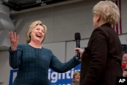 Democratic presidential candidate Hillary Clinton reacts as former Secretary of State Madeleine Albright introduces Clinton at a campaign event at Rundlett Middle School, in Concord, N.H., Feb. 6, 2016.