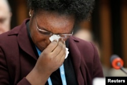 FILE - Health worker and Ebola survivor from Sierra Leone Mme Rebecca Johnson cries after addressing the media during a special meeting on Ebola at the WHO headquarters in Geneva, Jan. 25, 2015.