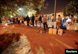 In Cape Town, South Africa, Jan. 25 2018, people wait their turn to take water from a spring in the Newlands suburb as fears over the city's water crisis grow.