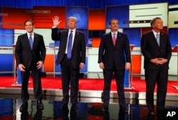 Republican presidential candidates, Sen. Marco Rubio, R-Fla., businessman Donald Trump, Sen. Ted Cruz, R-Texas, and Ohio Gov. John Kasich take the stage before a Republican presidential primary debate at Fox Theatre in Detroit, March 3, 2016.