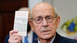 Supreme Court Associate Justice Stephen Breyer holds up a copy of the United States Constitution as he announces his retirement in the Roosevelt Room of the White House in Washington, Jan. 27, 2022.