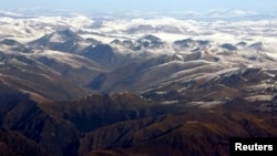 FILE - Tibetan Plateau in background of Himalayan range, viewed from flyover in Nepal.