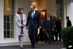 House Democratic leader Nancy Pelosi of California, left, walks with Senate Minority Leader Chuck Schumer, D-N.Y., as Democratic leaders including Sen. Dick Durbin, D-Ill., at right, arrive to speak to the media after meeting with President Donald Trump, Jan. 4, 2019.