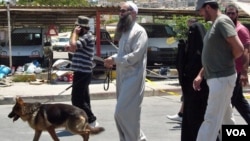 Ahmad Assir walks his dog with family members and bodyguards in Sidon July 5, 2012 (VOA/Jeff Neumann).