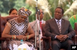 FILE - Zimbabwean first lady Grace Mugabe (L) sits next to vice President Emmerson Mnangagwa at the Zanu pf headquarters in Harare, Feb, 10, 2016.