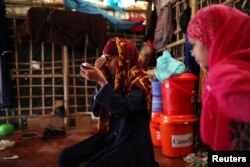 Formin Akter applies makeup before heading to Chittagong to attend school at the Asian University for Women in Cox's Bazar, Bangladesh, Aug. 24, 2018.