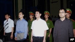 FILE - From left to right : Tran Huynh Duy Thuc, Nguyen Tien Trung, Le Thang Long and Le Cong Dinh listen to the verdict at a court in Ho Chi Minh City, Jan. 20, 2010.