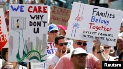 Immigration activists hold signs against family separation during a rally to protest against the Trump Administration's immigration policy, outside the White House in Washington, June 30, 2018.