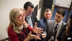 FILE - Rep. Debbie Dingell, D-Mich., talks to reporters in Washington, Nov. 29, 2017.