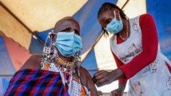A Maasai woman receives the AstraZeneca coronavirus vaccine at a clinic in Kimana, southern Kenya, Aug. 28, 2021.