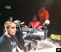 Akeylah Hunter playing piano at the House of Blues in Boston during a sound check with Michael Franti and his band.