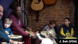 Baba Ras D shows children how to "pass the peace" at his Harambee program in Washington.