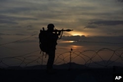FILE - A Pakistani border security guard stands alert at Pakistan-Afghanistan border post, Chaman in Pakistan, May 5, 2017.