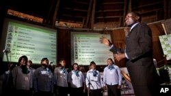 In an attempt to fill the long stretches of time without briefings to the media or announcement of electoral results, a choir sings songs in front of electoral results boards at the National Tallying Center